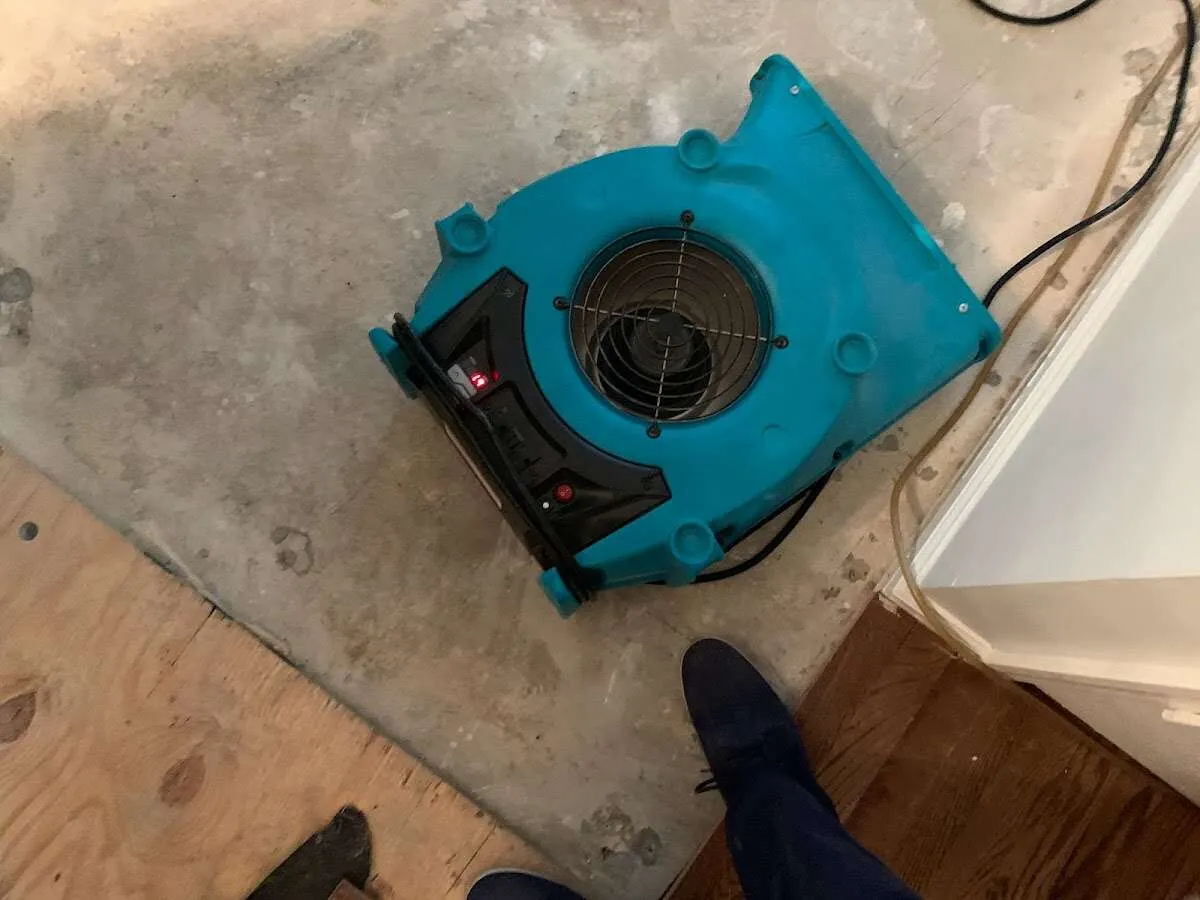 Air mover drying subfloor during Leak Detection & Repair in West Fargo